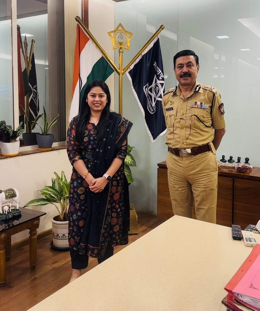 Ashutosh Dumbare in Maharashtra Police uniform standing with a visitor at the Thane police commissioner's office.